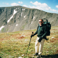 In this 1998 photo, Ken Kambis is descending Mount Elbert, with Mount William & Mary in the background.
